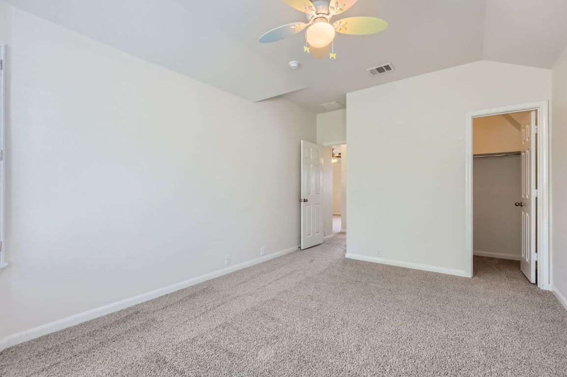 3423 Shiraz Loop Round Rock, TX 78665 - Photo 22 of 28 an empty room with a chandelier fan