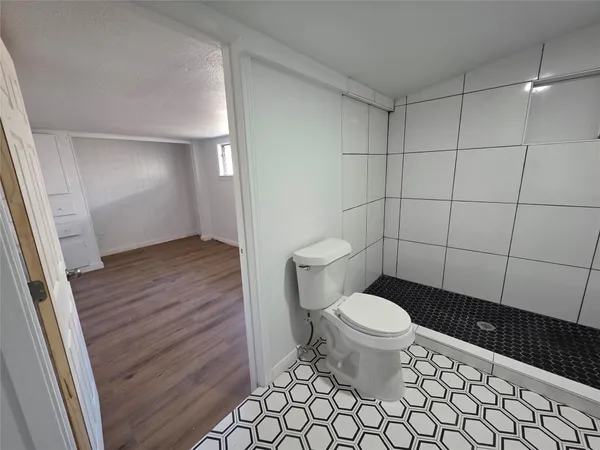 a bathroom with a toilet and a shower