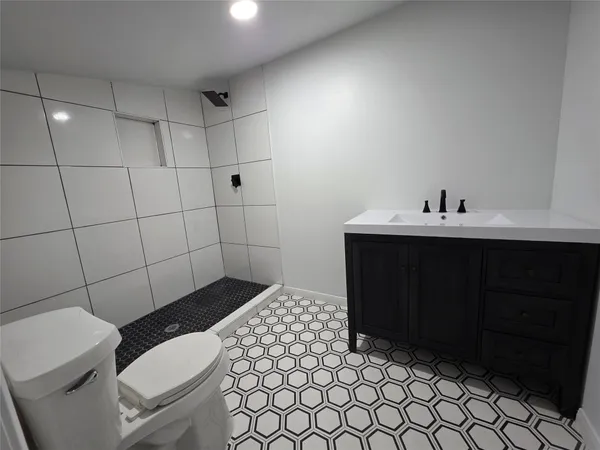 a bathroom with a sink toilet and vanity