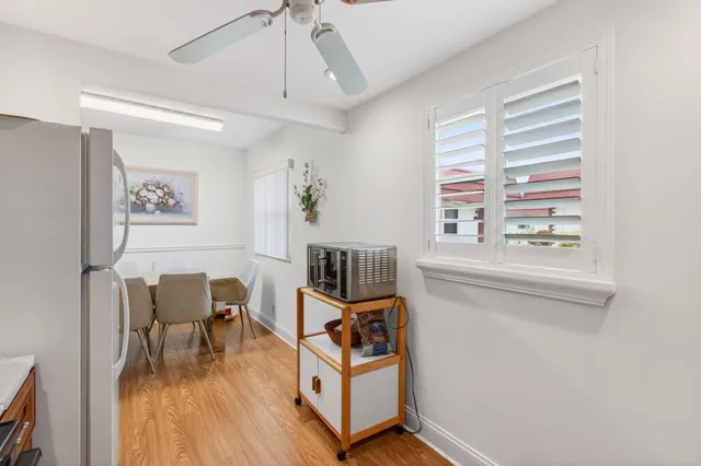 a view of a dining room with furniture wooden floor and a chandelier
