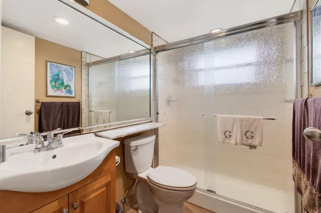 a bathroom with a shower a toilet and a sink