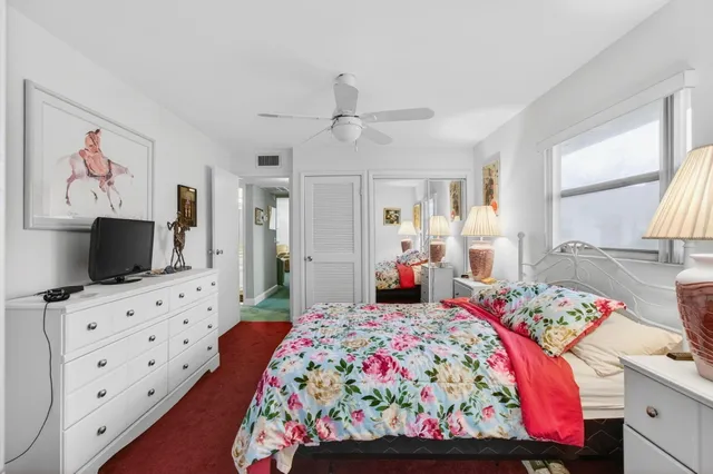 a view of a room with wooden floor and fan