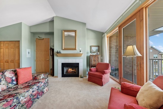 1705 Pavilion Way, Unit 504 Park Ridge, IL 60068 - Photo 5 of 15 a living room with furniture or outdoor space and a fireplace