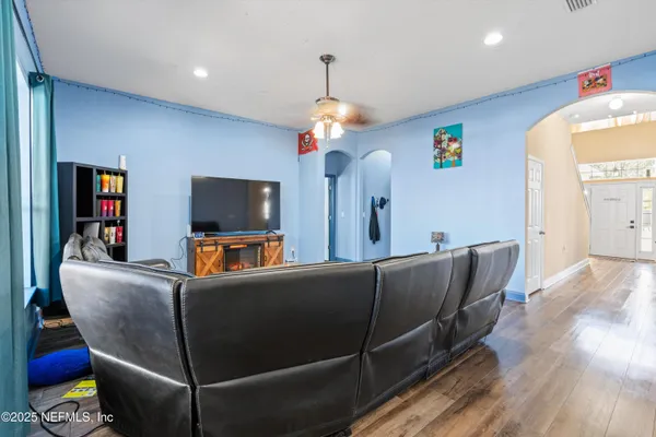 a living room with furniture and a flat screen tv