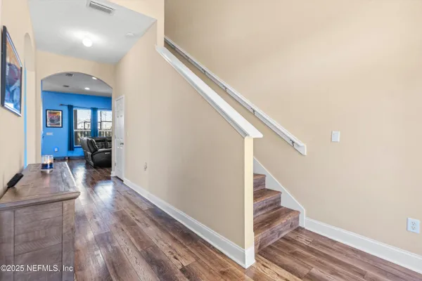 a view of a hallway view with wooden floor and staircase