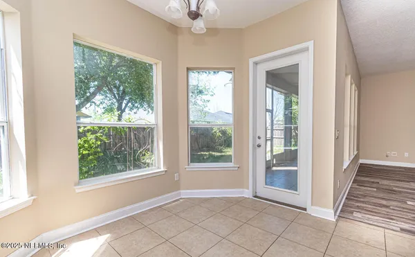 a view of an entryway with wooden floor and door