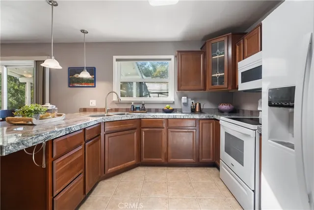 a kitchen with stainless steel appliances granite countertop a sink and dishwasher a stove top oven with wooden floor
