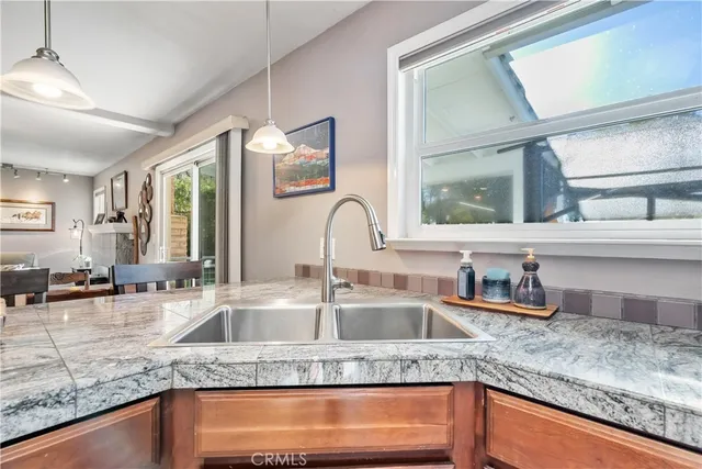 a kitchen with granite countertop a sink and a window