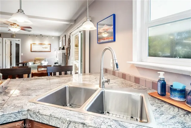 a kitchen with stainless steel appliances granite countertop a sink and a window