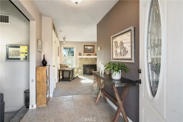 a living room with fireplace furniture and a table