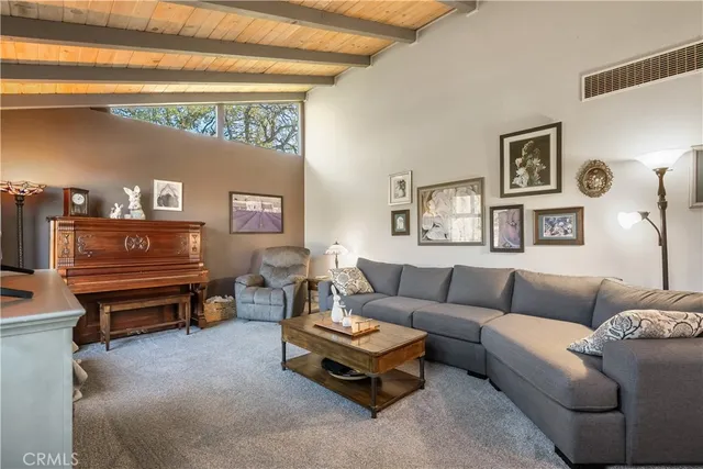 a living room with furniture and painting on the wall
