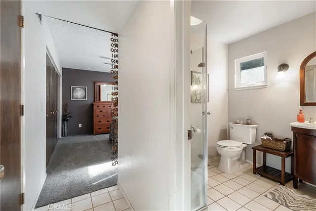 a bathroom with a glass door shower and a toilet