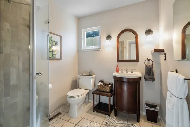 a view of bathroom with a toilet sink and a mirror