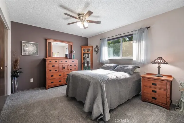 a bedroom with a bed closet and window