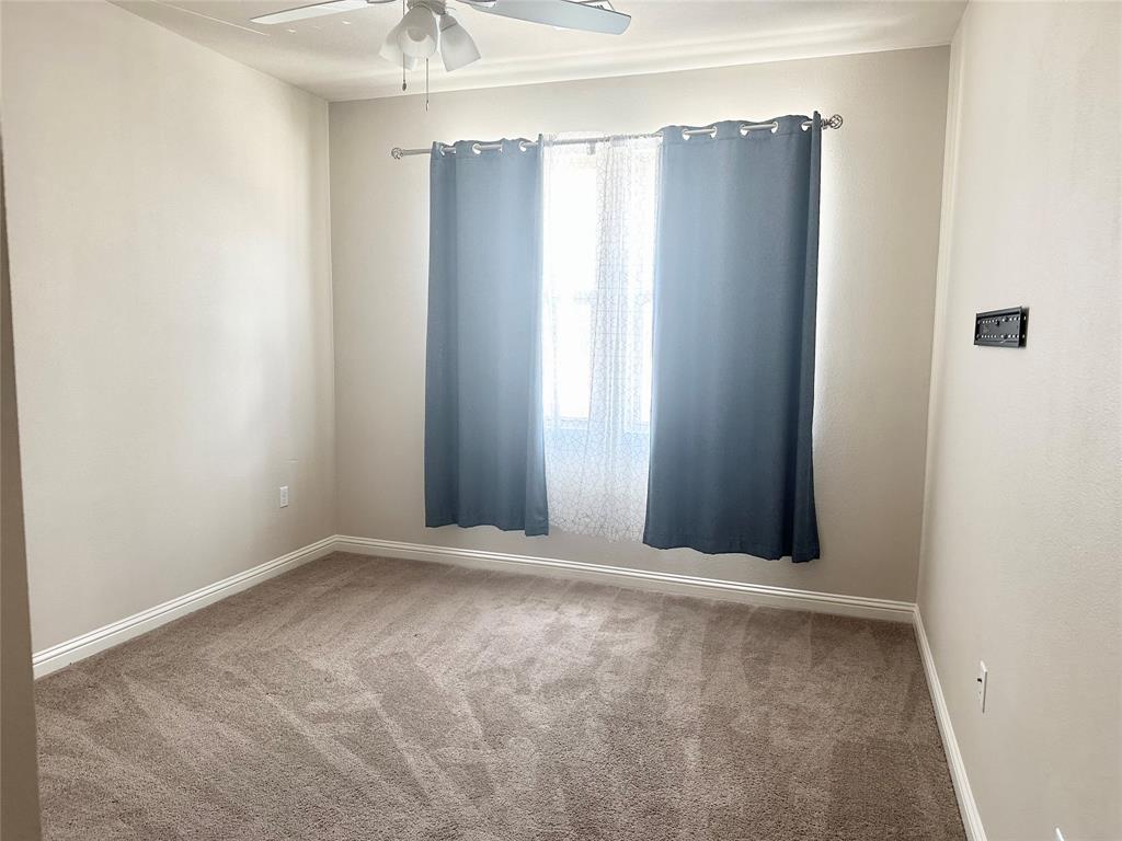 6814 East Riverside Drive, Unit 26 Austin, TX 78741 - Photo 18 of 21 A well-lit bedroom offering soft carpeting and essential comfort.