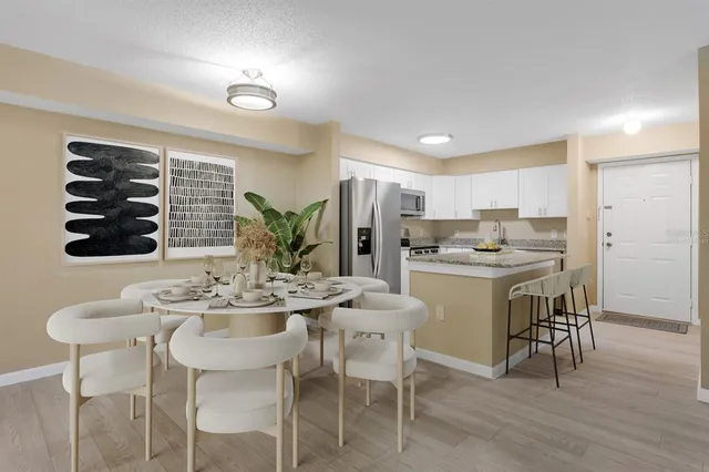 a kitchen with a refrigerator sink and cabinets