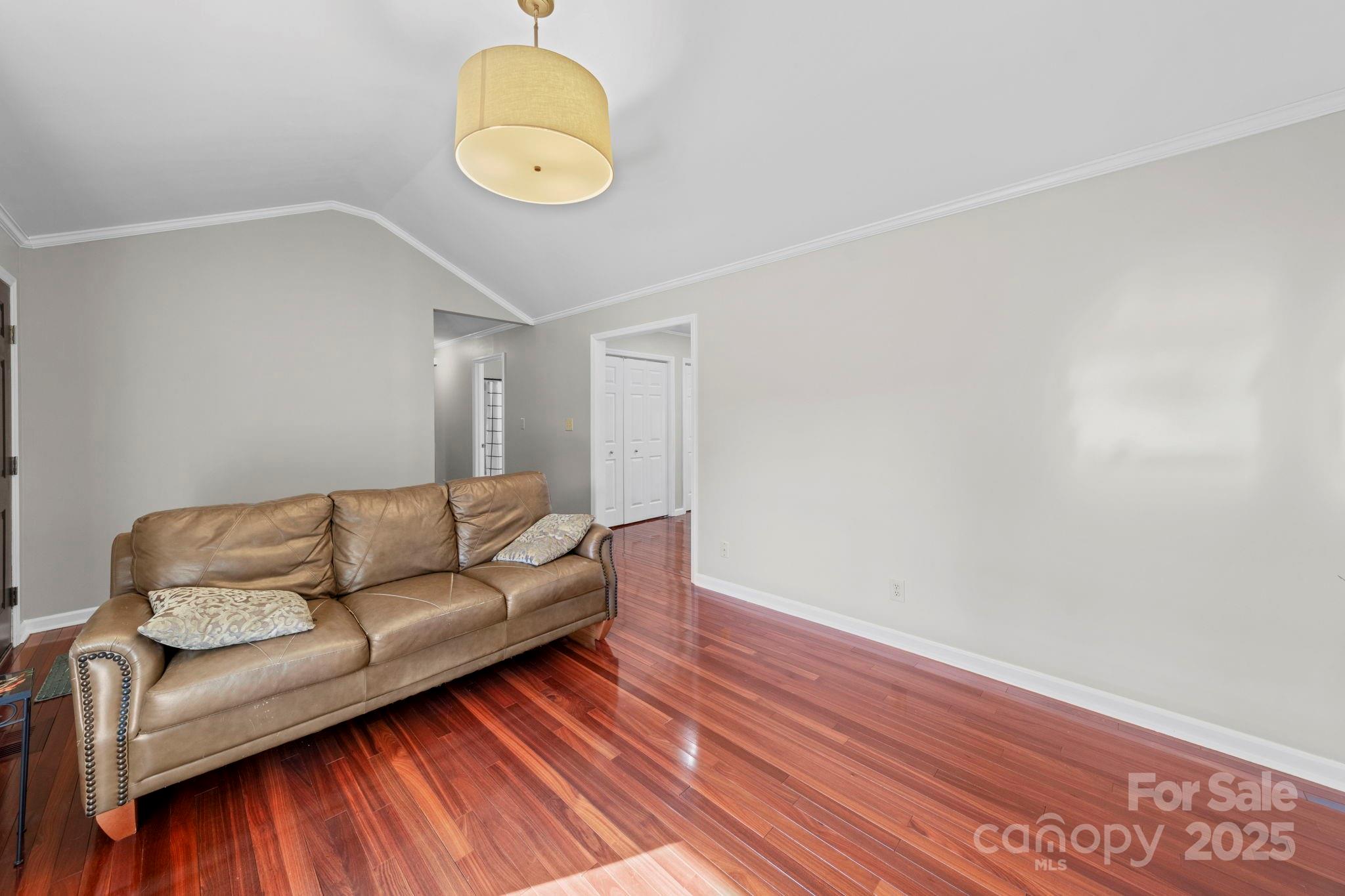 3400 Griffith Road Monroe, NC 28112 - Photo 18 of 46 a living room with a couch and chandelier