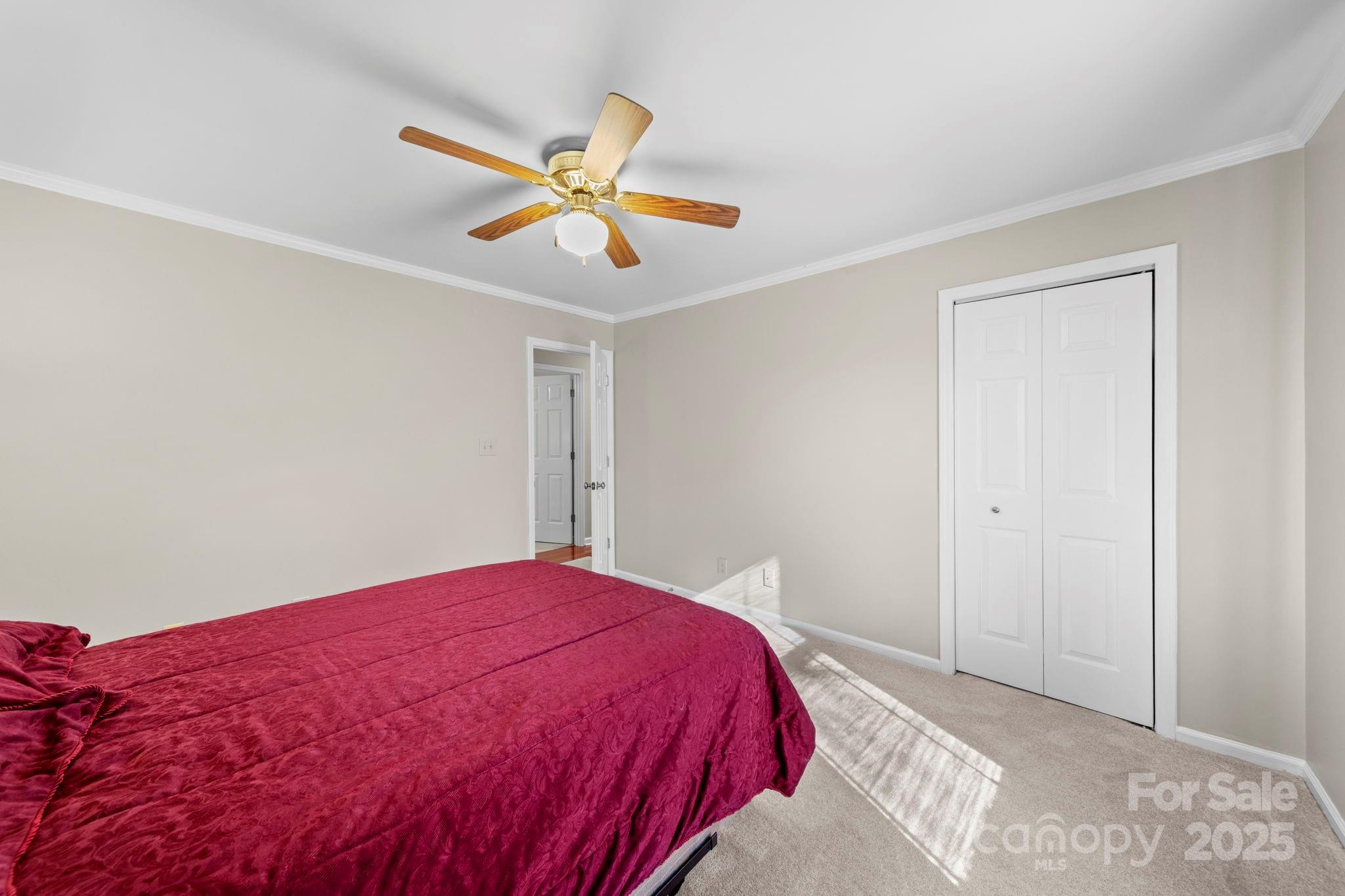 3400 Griffith Road Monroe, NC 28112 - Photo 24 of 46 a bedroom with a bed and a chandelier