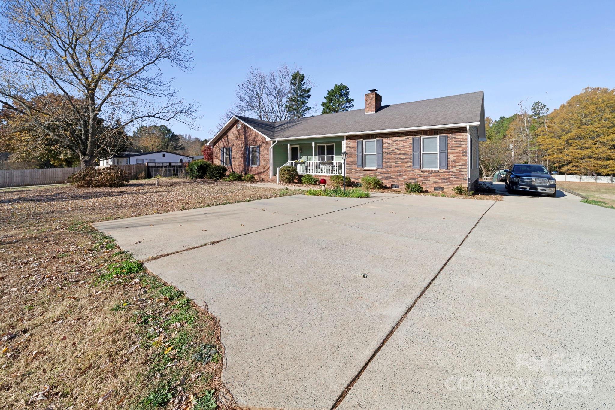 3400 Griffith Road Monroe, NC 28112 - Photo 3 of 46 a front view of house with yard outdoor seating and covered with trees