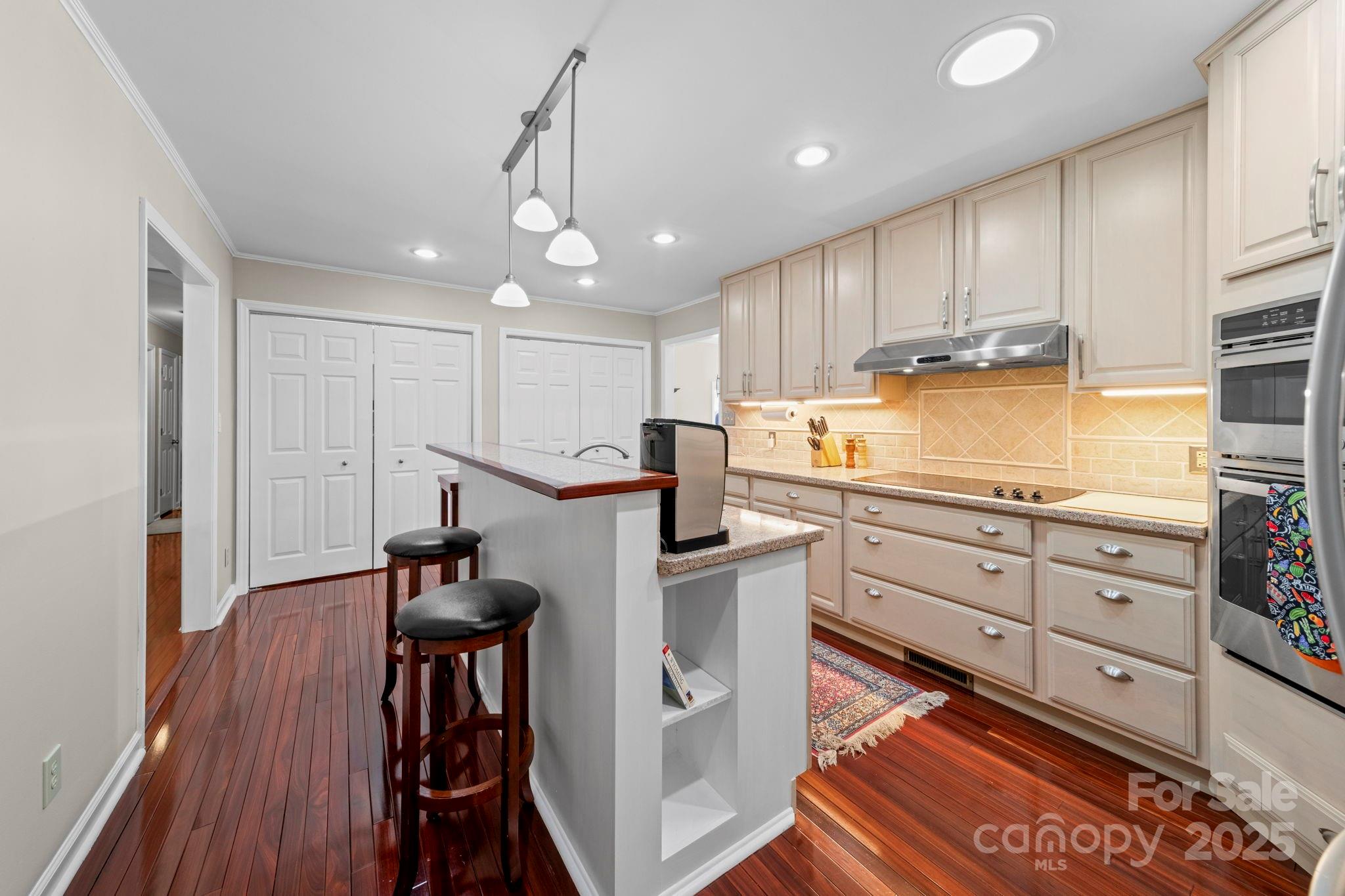 3400 Griffith Road Monroe, NC 28112 - Photo 35 of 46 a kitchen with stainless steel appliances granite countertop a refrigerator and a stove top oven