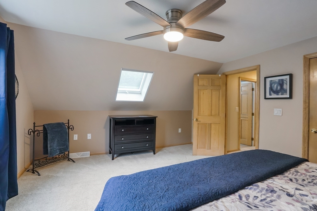 13 Taft Drive Franklin, MA 02038 - Photo 21 of 35 a bedroom with a bed and a ceiling fan