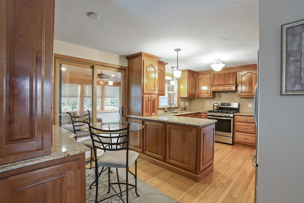 13 Taft Drive Franklin, MA 02038 - Photo 3 of 35 a kitchen with a table chairs stove and cabinets