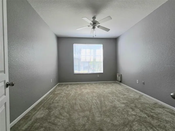 a view of an empty room and a window