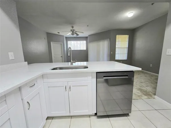 a kitchen with a sink and a mirror