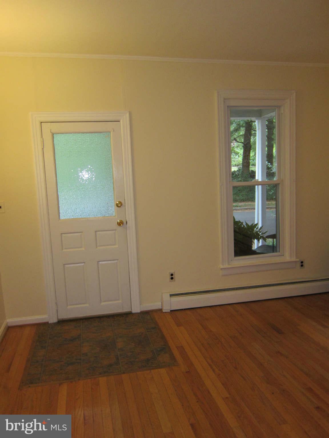 4525 Wilmslow Road Baltimore, MD 21210 - Photo 2 of 14 a view of an empty room with wooden floor and a window