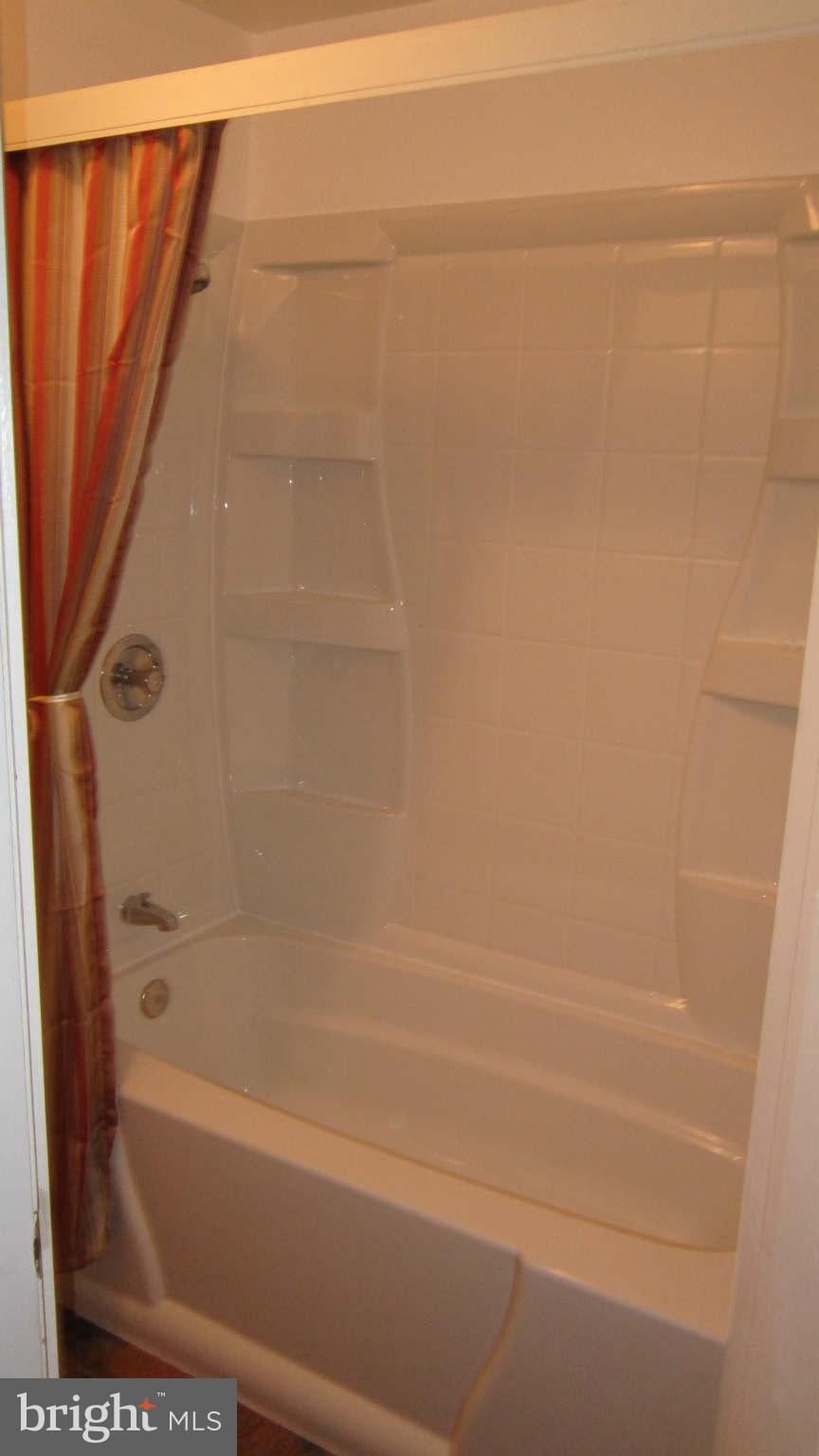 4525 Wilmslow Road Baltimore, MD 21210 - Photo 11 of 14 a bathroom with a shower and a bath tub