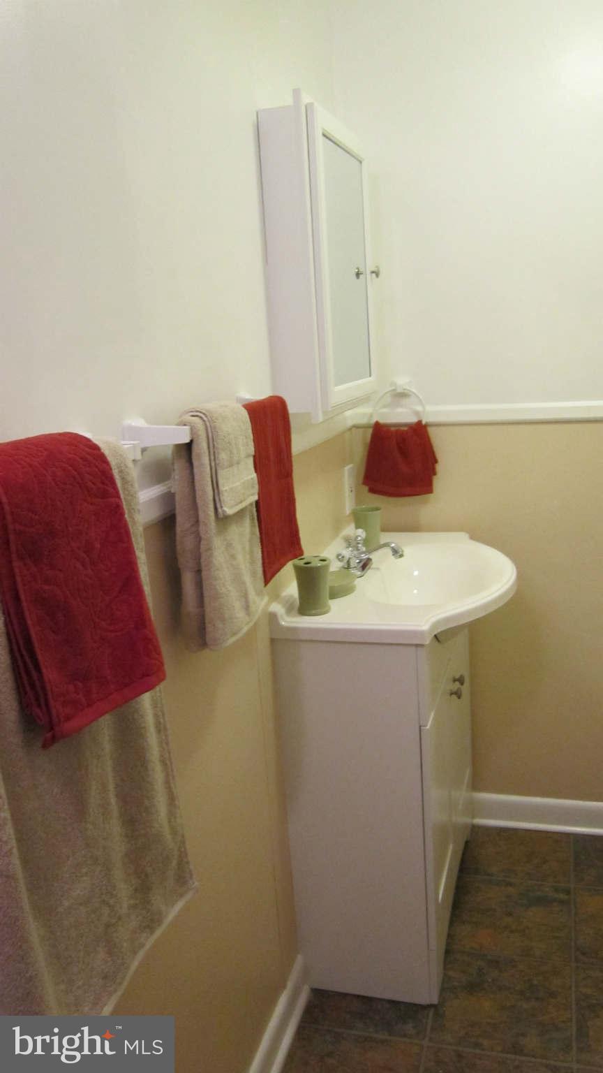 4525 Wilmslow Road Baltimore, MD 21210 - Photo 12 of 14 a bathroom with a sink and a mirror