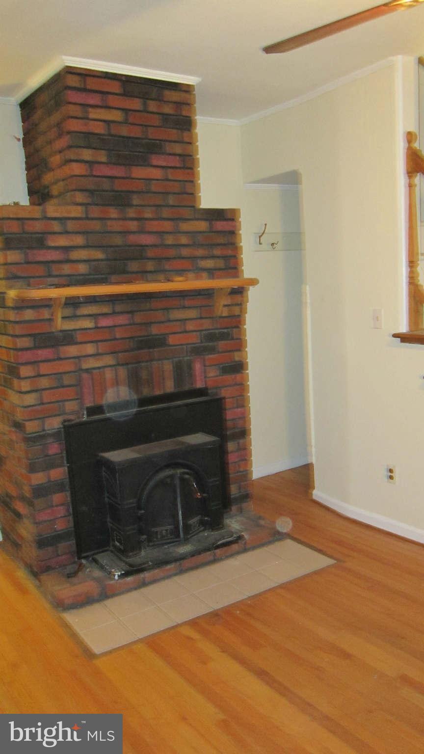 4525 Wilmslow Road Baltimore, MD 21210 - Photo 4 of 14 a view of fireplace and wooden floor