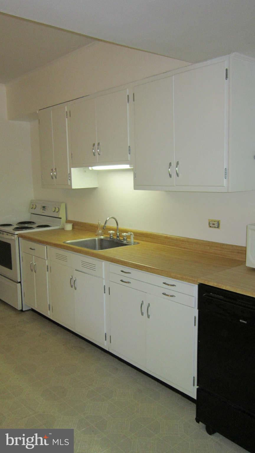 4525 Wilmslow Road Baltimore, MD 21210 - Photo 6 of 14 a kitchen with granite countertop white cabinets and white appliances