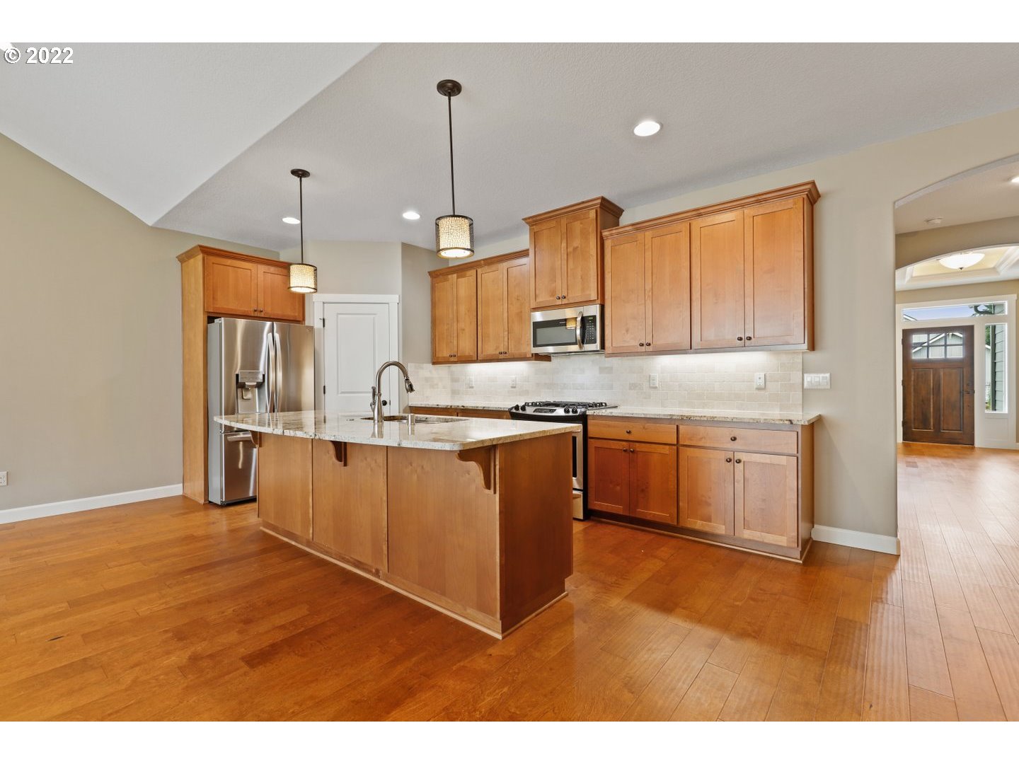 1719 Northeast 175th Street Ridgefield, WA 98642 - Photo 16 of 32 a kitchen with kitchen island granite countertop a sink cabinets and stainless steel appliances