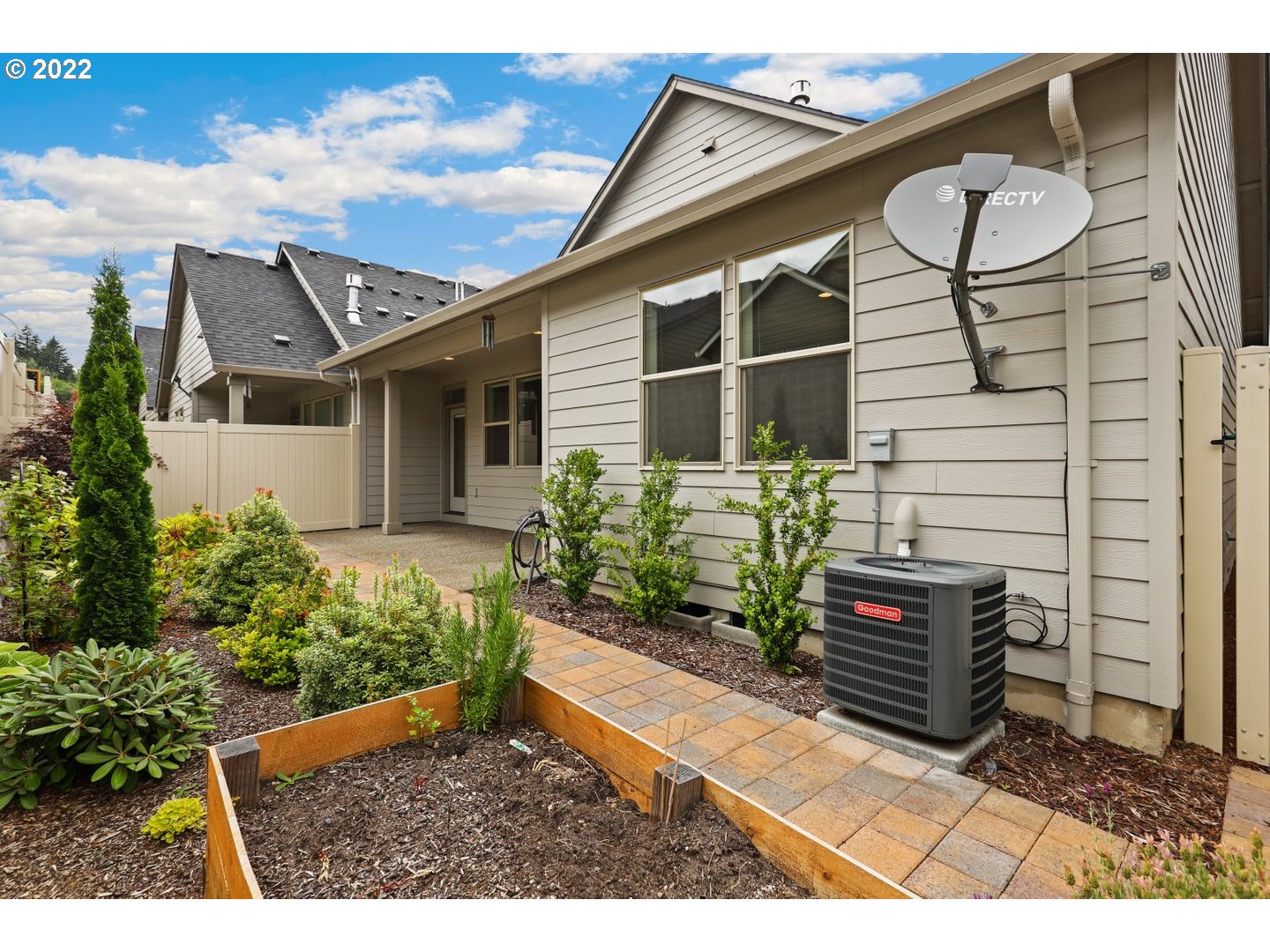 1719 Northeast 175th Street Ridgefield, WA 98642 - Photo 30 of 32 a backyard of a house with potted plants and more windows