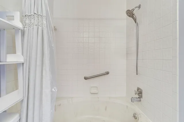 a bathroom with a shower and a bath tub