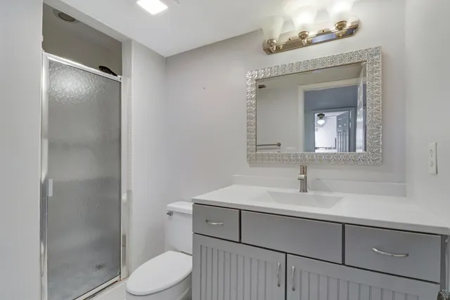 a bathroom with a sink toilet and shower