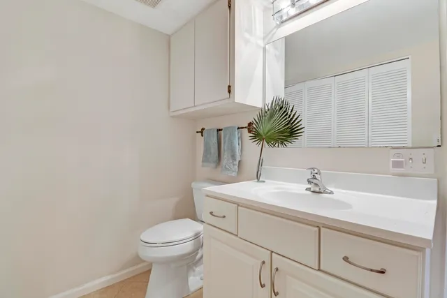 a bathroom with a sink a toilet and mirror