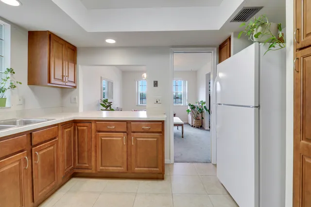 a kitchen with stainless steel appliances a refrigerator sink and cabinets