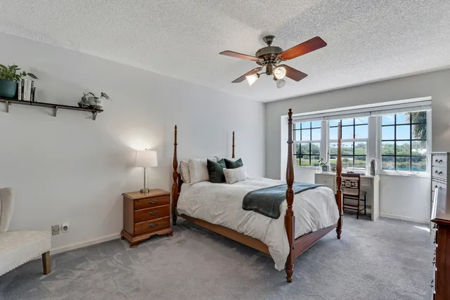 a spacious bedroom with a bed and a chandelier