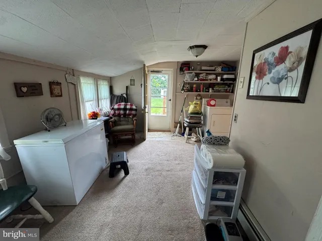 a living room with furniture a piano and a flat screen tv