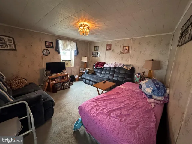 a bedroom with furniture and a window