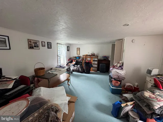 a living room with furniture and a dresser