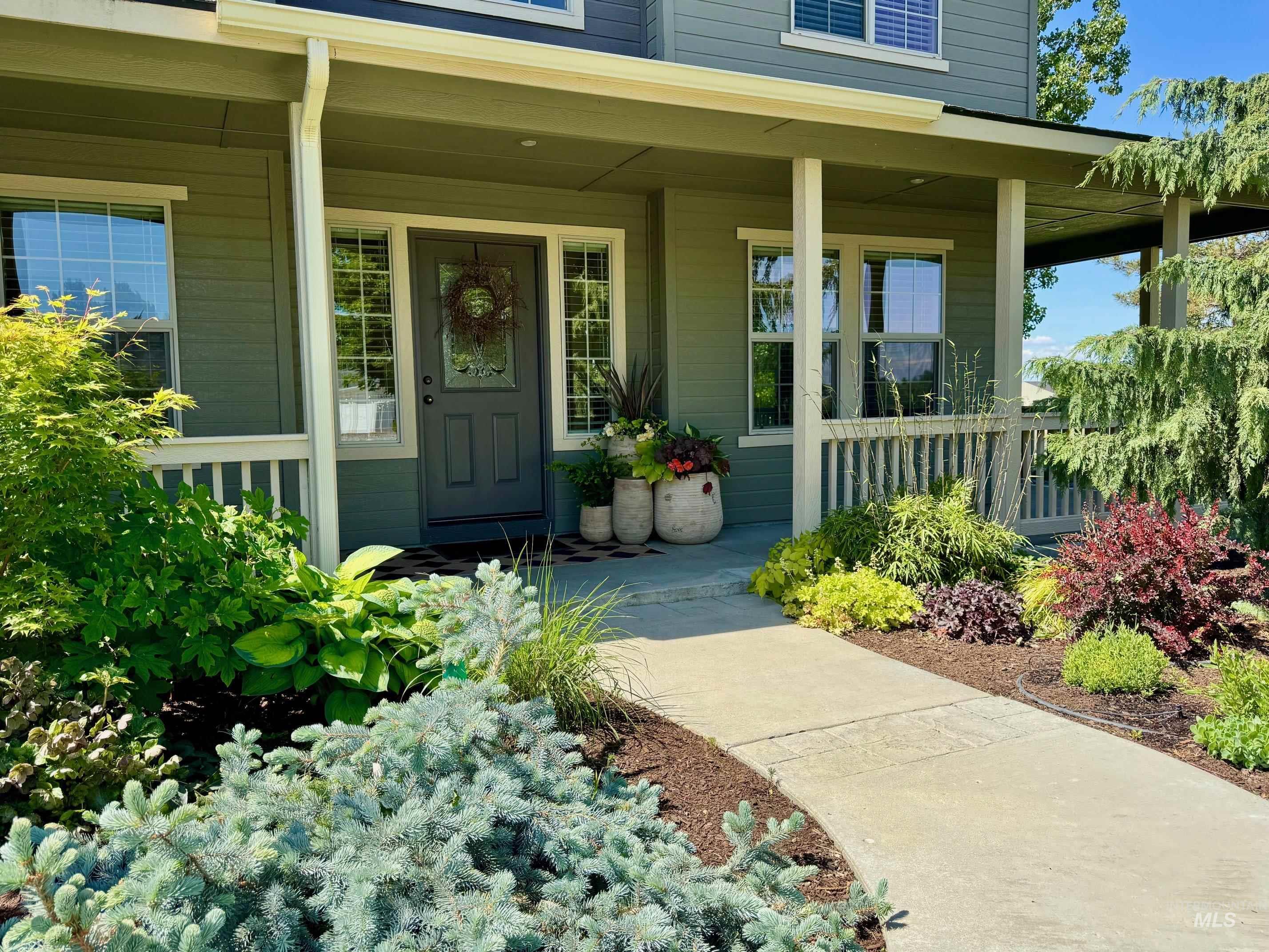 9299 Kemp Road Middleton, ID 83644 - Photo 5 of 50 Entryway featuring a covered porch, paneled door with glass insert, and sidelight windows