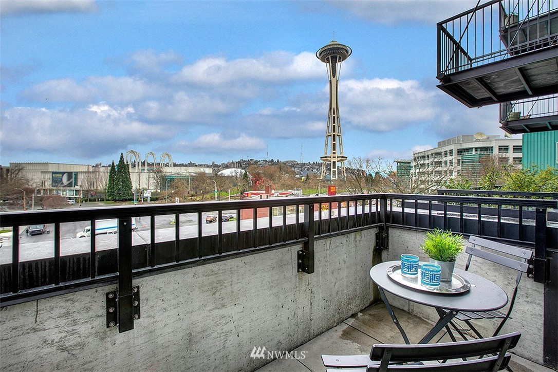 2720 3rd Avenue, Unit 502 Seattle, WA 98121 - Photo 14 of 28 a view of a balcony with chairs and a potted plant