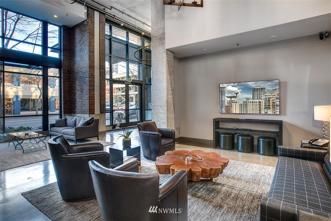 2720 3rd Avenue, Unit 502 Seattle, WA 98121 - Photo 18 of 28 a living room with furniture and a fireplace