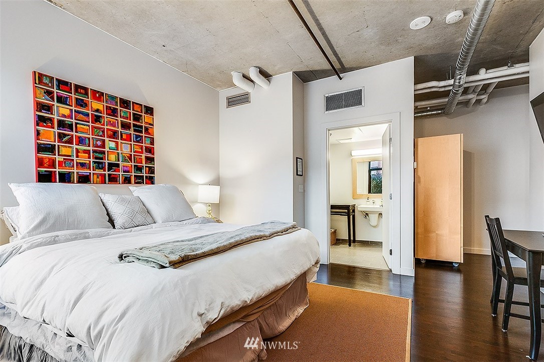 2720 3rd Avenue, Unit 502 Seattle, WA 98121 - Photo 23 of 28 a bedroom with a bed and wooden floor