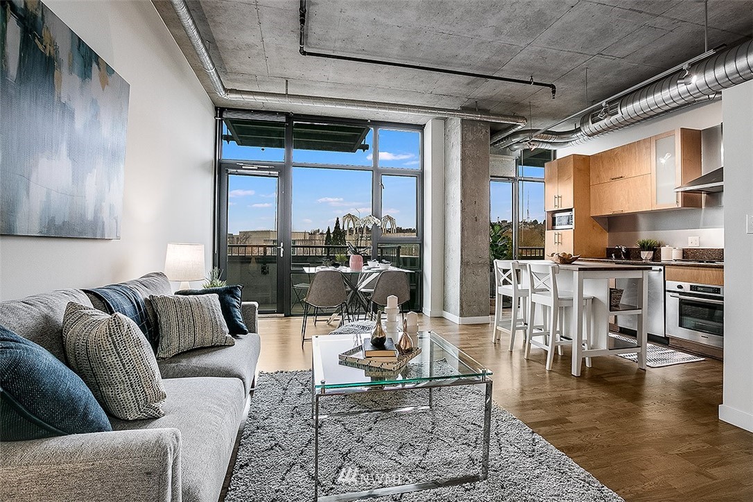 2720 3rd Avenue, Unit 502 Seattle, WA 98121 - Photo 4 of 28 a living room with furniture and a fireplace