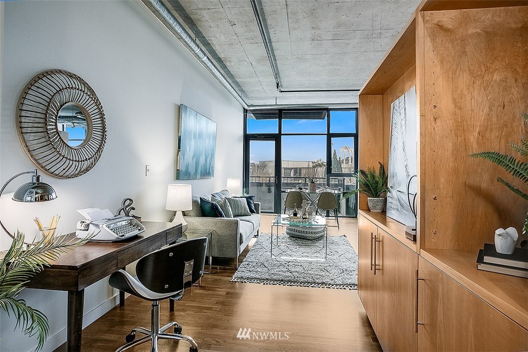 2720 3rd Avenue, Unit 502 Seattle, WA 98121 - Photo 5 of 28 a living room with furniture and a floor to ceiling window