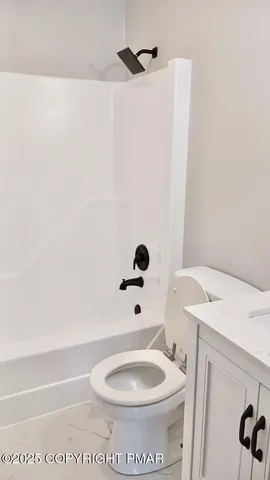 a bathroom with a toilet and a sink